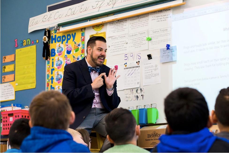 Image of Andrew Deacon in front of students in his classroom
