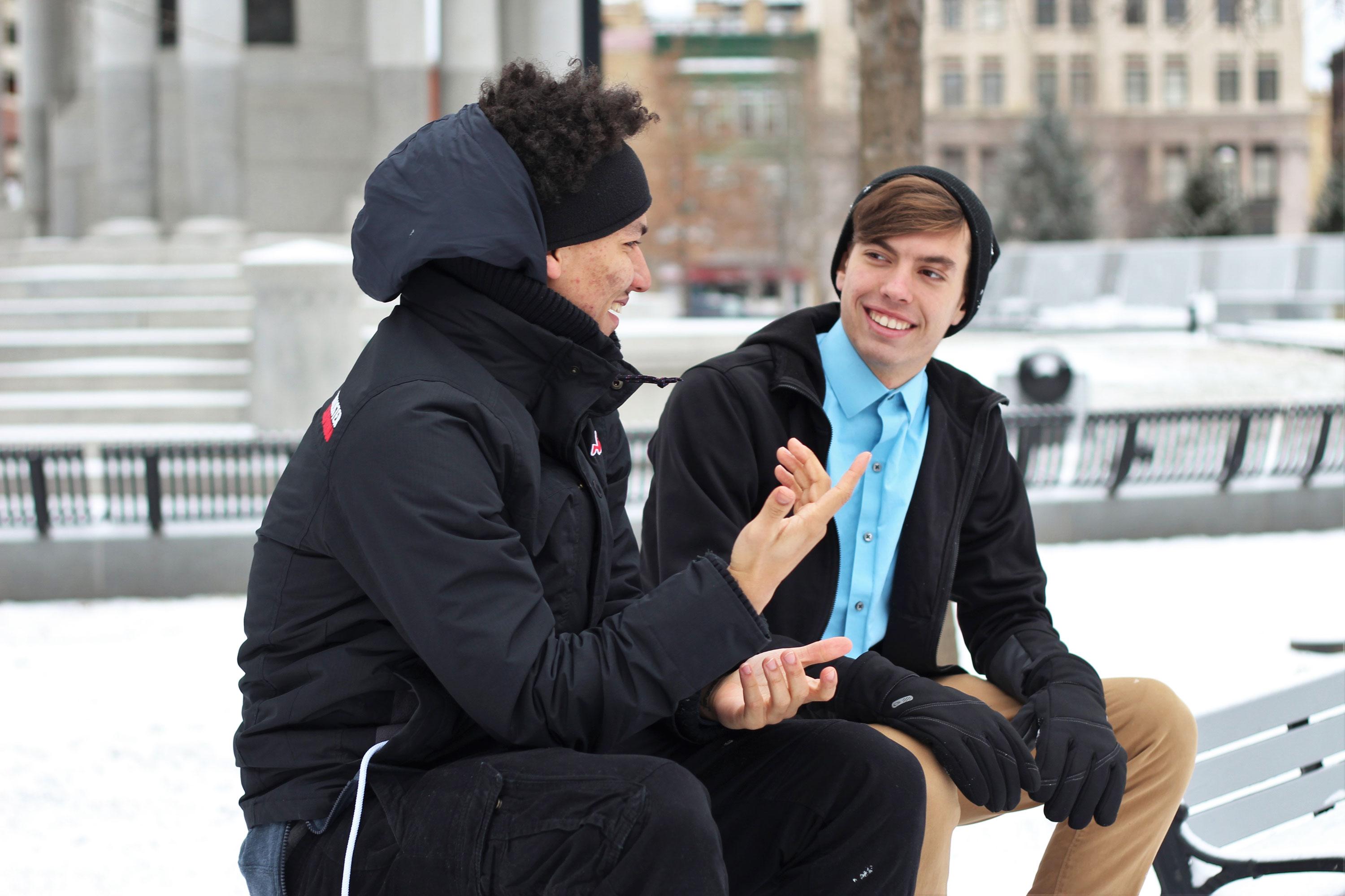 Two men talking outside in the winter
